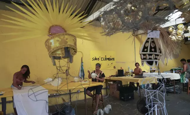 Sao Clemente samba school workers make costumes for Carnival, in Rio de Janeiro, Thursday, Nov. 28, 2024. (AP Photo/Silvia Izquierdo)