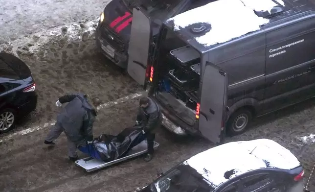 Workers load a body of Lt. General Igor Kirillov, the head of Russia's Nuclear, Biological, and Chemical Defence Forces into a bus after he and his assistant Ilya Polikarpov were killed by an explosive device planted close to a residential apartment's block in Moscow, Russia, Tuesday, Dec. 17, 2024. (AP Photo)