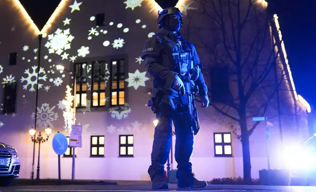 A police officer guards at a cordoned-off area near a Christmas Market after an incident in Magdeburg, Germany, Friday, Dec. 20, 2024. (AP Photo/Ebrahim Noroozi)