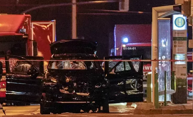 The car that was crashed into a crowd of people at the Magdeburg Christmas market is seen following the attack in Magdeburg, Germany, Saturday early morning, Dec. 21, 2024. (AP Photo/Ebrahim Noroozi)