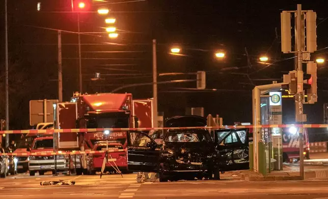 The car that was crashed into a crowd of people at the Magdeburg Christmas market is seen following the attack in Magdeburg, Germany, Saturday early morning, Dec. 21, 2024. (AP Photo/Ebrahim Noroozi)