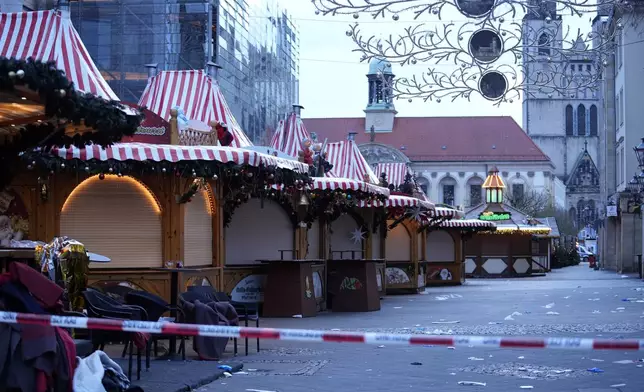 Police tape cordons-off a Christmas Market, where a car drove into a crowd on Friday evening, in Magdeburg, Germany, Saturday, Dec. 21, 2024. (AP Photo/Ebrahim Noroozi)