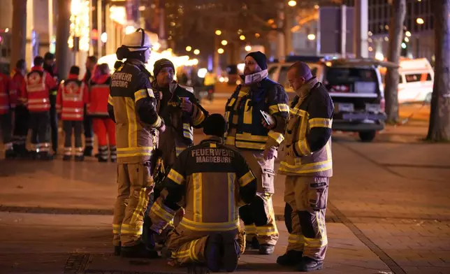 Emergency services work in a cordoned-off area near a Christmas Market, after a car drove into a crowd in Magdeburg, Germany, Friday, Dec. 20, 2024. (AP Photo/Ebrahim Noroozi)