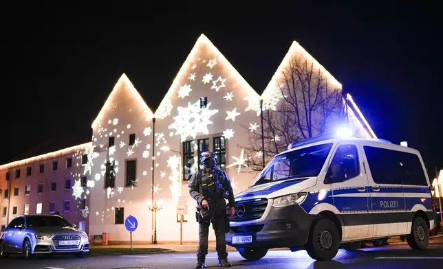 A police officer guards at a blocked road near a Christmas market after an incident in Magdeburg, Germany, Friday, Dec. 20, 2024. (AP Photo/Ebrahim Noroozi)