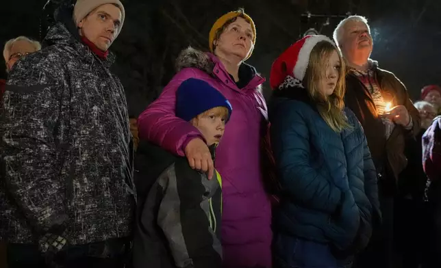 Supporters hold candles during a candlelight vigil Tuesday, Dec. 17, 2024, outside the Wisconsin Capitol in Madison, Wis., following a shooting at the Abundant Life Christian School on Monday, Dec. 16. (AP Photo/Morry Gash)