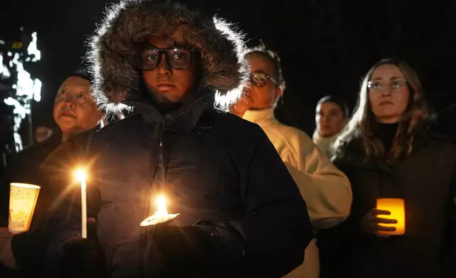 Supporters hold candles during a candlelight vigil Tuesday, Dec. 17, 2024, outside the Wisconsin Capitol in Madison, Wis., following a shooting at the Abundant Life Christian School on Monday, Dec. 16. (AP Photo/Morry Gash)