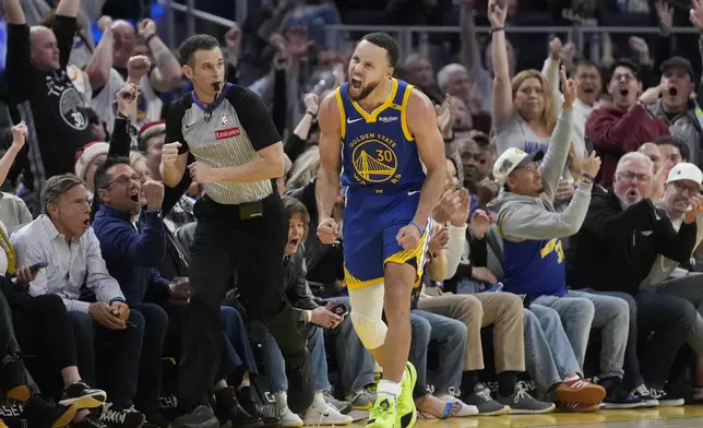 Golden State Warriors guard Stephen Curry (30) reacts after making a 3-point basket during the second half of an NBA basketball game against the Indiana Pacers in San Francisco, Monday, Dec. 23, 2024. (AP Photo/Jeff Chiu)