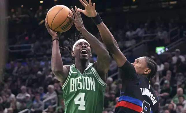 Boston Celtics guard Jrue Holiday (4) drives to the basket past Detroit Pistons forward Ausar Thompson (9) during the first half of an NBA basketball game, Thursday, Dec. 12, 2024, in Boston. (AP Photo/Charles Krupa)