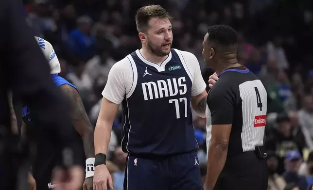 Dallas Mavericks guard Luka Doncic (77) questions a call by referee Sean Wright (4) during the first half of an NBA basketball game against the Portland Trail Blazers, Monday, Dec. 23, 2024, in Dallas. (AP Photo/LM Otero)