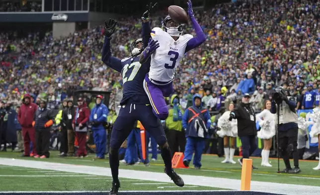 Seattle Seahawks cornerback Riq Woolen (27) breaks up a pass intended for Minnesota Vikings wide receiver Jordan Addison (3) during the first half of an NFL football game, Sunday, Dec. 22, 2024, in Seattle. (AP Photo/Lindsey Wasson)