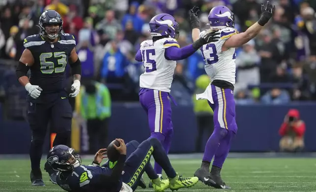 Minnesota Vikings linebacker Andrew Van Ginkel (43), right, celebrates after sacking Seattle Seahawks quarterback Geno Smith (7) during the second half of an NFL football game, Sunday, Dec. 22, 2024, in Seattle. (AP Photo/Lindsey Wasson)