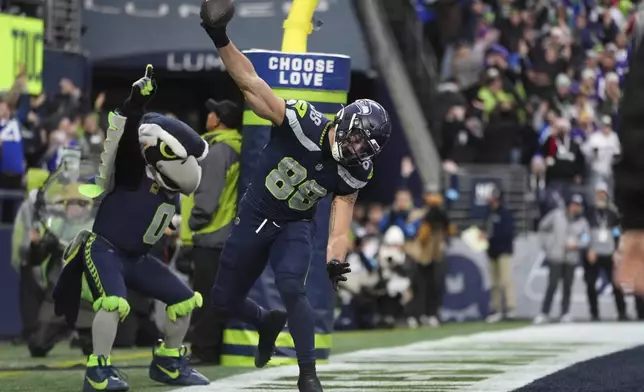 Seattle Seahawks tight end AJ Barner (88) celebrates after catching a 4-yard touchdown pass during the second half of an NFL football game against the Minnesota Vikings, Sunday, Dec. 22, 2024, in Seattle. (AP Photo/Lindsey Wasson)