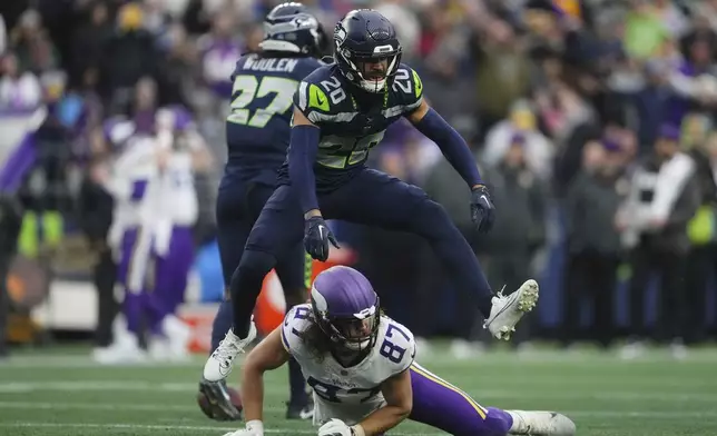 Seattle Seahawks safety Julian Love (20) celebrates after forcing a incomplete pass intended for Minnesota Vikings tight end T.J. Hockenson (87) during the second half of an NFL football game, Sunday, Dec. 22, 2024, in Seattle. (AP Photo/Lindsey Wasson)