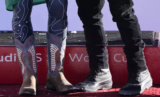 Second place finisher Brazil's Lucas Pinheiro Braathen, left, wears cowboy boots during a medal ceremony after a men's World Cup giant slalom skiing race, Sunday, Dec. 8, 2024, in Beaver Creek. (AP Photo/John Locher)