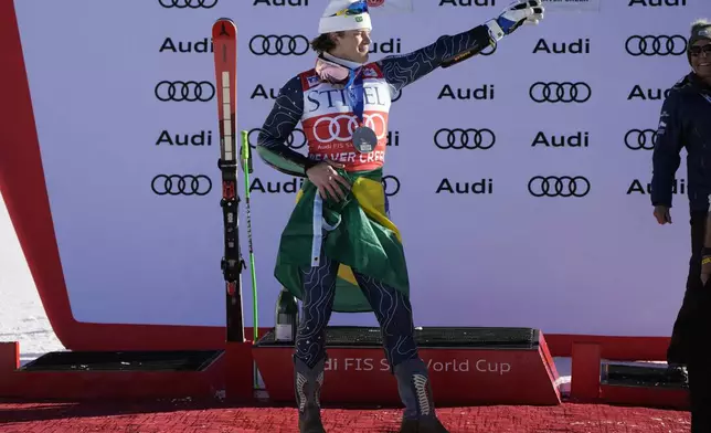 Second place finisher Brazil's Lucas Pinheiro Braathen celebrates with a Brazilian flag tied around his waist after a men's World Cup giant slalom skiing race, Sunday, Dec. 8, 2024, in Beaver Creek. (AP Photo/John Locher)