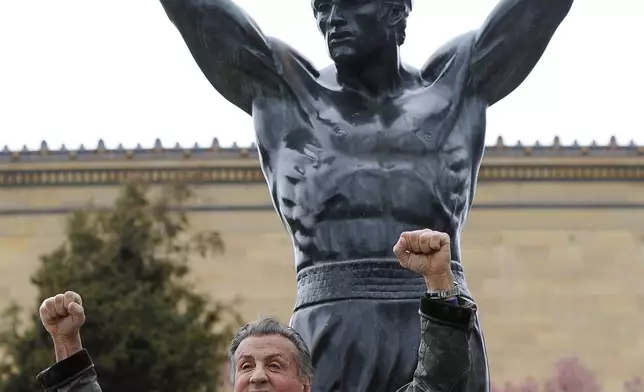 FILE - Sylvester Stallone poses in front of the Rocky statue at the Philadelphia Art Museum at a photo op to promote "Creed II" in Philadelphia on Friday, April 6, 2018. (AP Photo/Michael Perez)