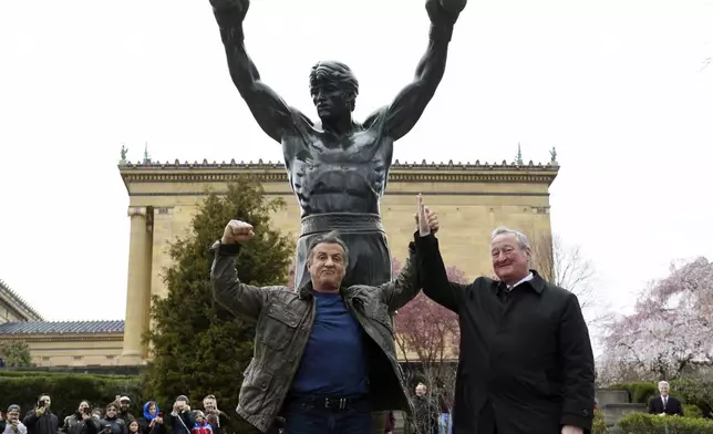 FILE - Sylvester Stallone, left, poses with Philadelphia Mayor Jim Kenney in front of the Rocky statue at the Philadelphia Art Museum for a "Creed II" photo op, Friday, April 6, 2018, in Philadelphia.(AP Photo/Michael Perez)