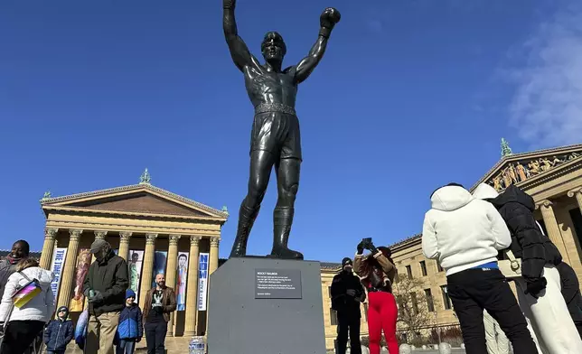 Visitors gather around the Rocky Statue and the “Rocky Steps” during RockyFest 2024 at the Philadelphia Museum of Art, Tuesday, Dec. 3, 2024, in Philadelphia. (AP Photo Tassanee Vejpongsa)