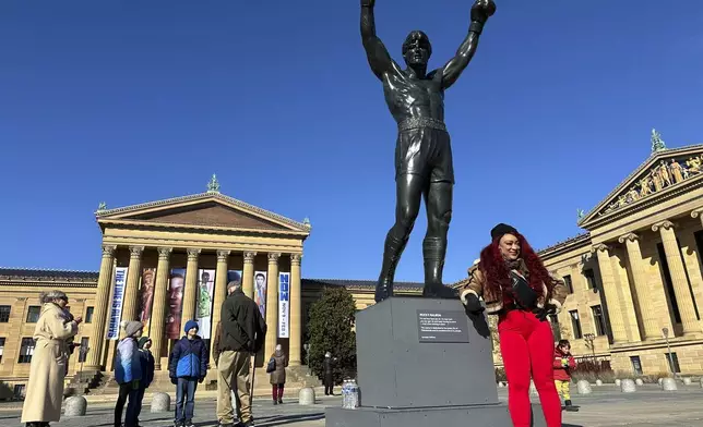 Visitors gather around the Rocky Statue and the “Rocky Steps” during RockyFest 2024 at the Philadelphia Museum of Art, Tuesday, Dec. 3, 2024, in Philadelphia. (AP Photo Tassanee Vejpongsa)