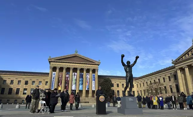 Visitors gather around the Rocky Statue and the “Rocky Steps” during RockyFest 2024 at the Philadelphia Museum of Art, Tuesday, Dec. 3, 2024, in Philadelphia. (AP Photo Tassanee Vejpongsa)