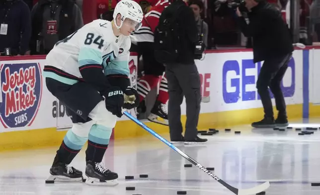 Seattle Kraken's Kaapo Kakko warms up before an NHL hockey game against the Chicago Blackhawks in Chicago, Thursday, Dec. 19, 2024. (AP Photo/Nam Y. Huh)