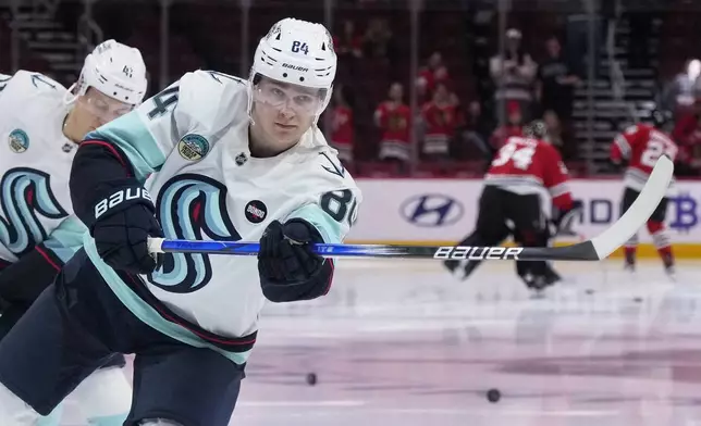 Seattle Kraken's Kaapo Kakko (84) warms up before an NHL hockey game against the Chicago Blackhawks in Chicago, Thursday, Dec. 19, 2024. (AP Photo/Nam Y. Huh)