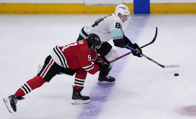 Seattle Kraken forward Kaapo Kakko, right, controls the puck past Chicago Blackhawks center Frank Nazar during the third period of an NHL hockey game in Chicago, Thursday, Dec. 19, 2024. The Blackhawks won 3-1. (AP Photo/Nam Y. Huh)