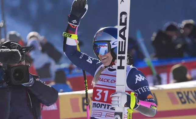 United States' Lindsey Vonn celebrates at the finish area of an alpine ski, women's World Cup super G, in St. Moritz, Switzerland, Saturday, Dec. 21, 2024. (AP Photo/Giovanni Auletta)