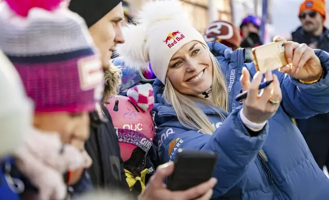 United States' Lindsey Vonn, takes a selfie in the finish area after completing an alpine ski, women's World Cup super G, in St. Moritz, Switzerland, Saturday, Dec. 21, 2024. (Jean-Christophe Bott/Keystone via AP)