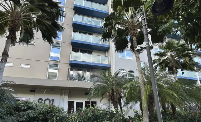 This photo shows the exterior of the apartment complex where the UnitedHealthcare CEO shooting suspect lived in Honolulu, Monday, Dec. 9, 2024. (AP Photo/Jennifer Kelleher)