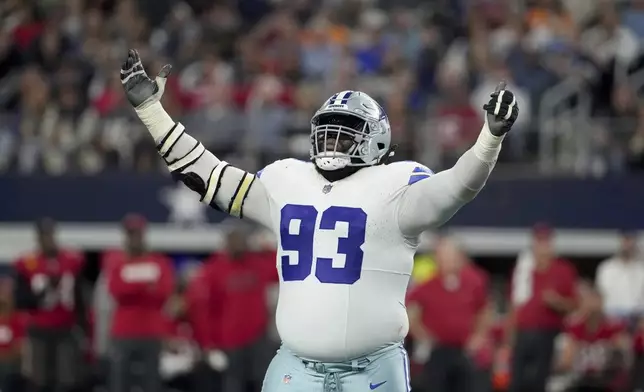 Dallas Cowboys defensive tackle Linval Joseph celebrates a sack of Tampa Bay Buccaneers quarterback Baker Mayfield in the second half of an NFL football game in Arlington, Texas, Sunday, Dec. 22, 2024. (AP Photo/Jeffrey McWhorter)