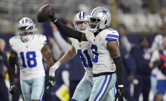 Dallas Cowboys' Donovan Wilson (6) celebrates with Nick Vigil (41) Wilson sacked Tampa Bay Buccaneers' Baker Mayfield (6) and recovered Mayfield's fumble in the second half of an NFL football game in Arlington, Texas, Sunday, Dec. 22, 2024. (AP Photo/Julio Cortez)