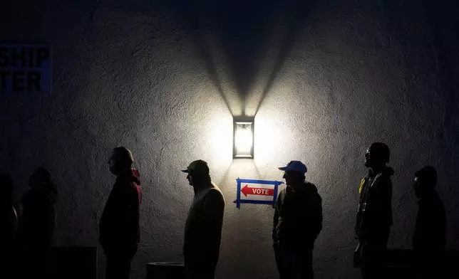 Voters stand in line outside a polling place at Madison Church, Tuesday, Nov. 5, 2024, in Phoenix, Ariz. (AP Photo/Matt York)