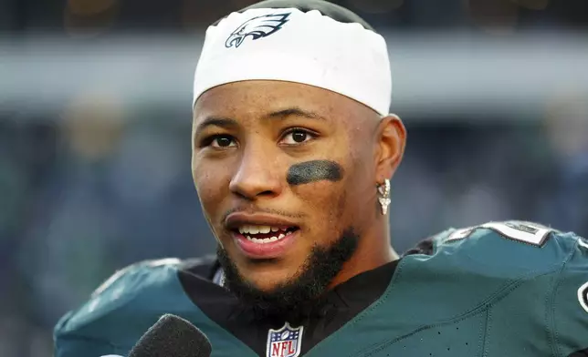 Philadelphia Eagles running back Saquon Barkley (26) speaks to the media after an NFL football game against the Carolina Panthers on Sunday, Dec. 8, 2024, in Philadelphia. (AP Photo/Derik Hamilton)