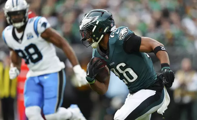 Philadelphia Eagles running back Saquon Barkley (26) runs with the ball during the first half of an NFL football game against the Carolina Panthers on Sunday, Dec. 8, 2024, in Philadelphia. (AP Photo/Derik Hamilton)