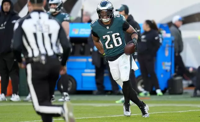 Philadelphia Eagles running back Saquon Barkley reacts after he set the Eagles' season rushing record during the second half of an NFL football game against the Carolina Panthers on Sunday, Dec. 8, 2024, in Philadelphia. (AP Photo/Chris Szagola)