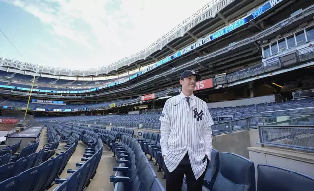 New York Yankees' Max Fried smiles while posing for photographs following a baseball news conference, Wednesday, Dec. 18, 2024, in New York. (AP Photo/Frank Franklin II)