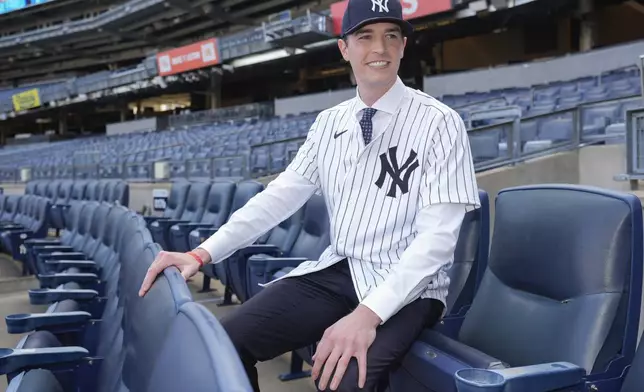 New York Yankees' Max Fried smiles while posing for photographs following a baseball news conference, Wednesday, Dec. 18, 2024, in New York. (AP Photo/Frank Franklin II)