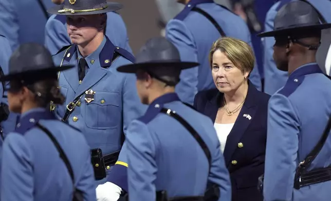 FILE - Massachusetts Gov. Maura Healey, right, walks among members of the 90th Recruit Training Group of the Massachusetts State Police, during a swearing in ceremony in Worcester, Mass., Oct. 9, 2024. (AP Photo/Steven Senne, File)