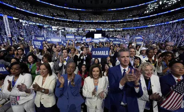 FILE - Rep. Nancy Pelosi, D-Calif., center, and California Gov. Gavin Newsom, center right, applaud as Democratic presidential nominee Vice President Kamala Harris speaks during the Democratic National Convention, in Chicago, Aug. 22, 2024. (AP Photo/Paul Sancya, File)