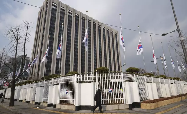 South Korean national flags fly at half-staff at a government complex in Seoul, South Korea, Monday, Dec. 30, 2024, a day after a jetliner skidded off a runway, slammed into a concrete fence and burst into flames at an airport the town of Muan. (AP Photo/Lee Jin-man)