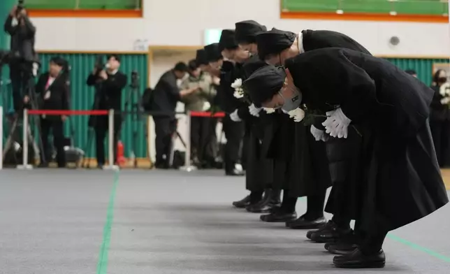 Nuns bow for the victims of a plane fire at a memorial altar at Muan sport park in Muan, South Korea, Monday, Dec. 30, 2024. (AP Photo/Ahn Young-joon)