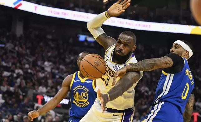 Los Angeles Lakers forward LeBron James (23) gets fouled by Golden State Warriors guard Gary Payton II (0) during the first half of an NBA basketball game Wednesday, Dec. 25, 2024, in San Francisco. (AP Photo/Eakin Howard)