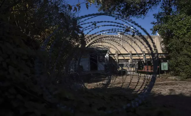 Barbed wires set in an area in front of a house of the Kibbutz Manara, which is located near to the border with Lebanon, in northern Israel, Monday Dec. 2, 2024. (AP Photo/Ohad Zwigenberg)