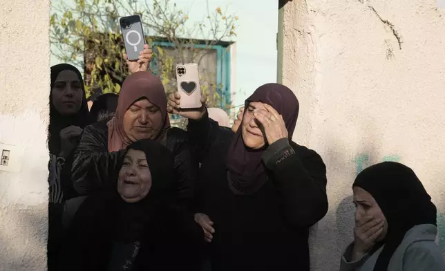 Mourners follow the funeral of Akram Abu Arrah and Mohammad Ghannam, both killed in an airstrike Israel said targeted a militant cell, in the West Bank village of Al-Aqaba, Tuesday Dec. 3, 2024. (AP Photo/Majdi Muhammad)