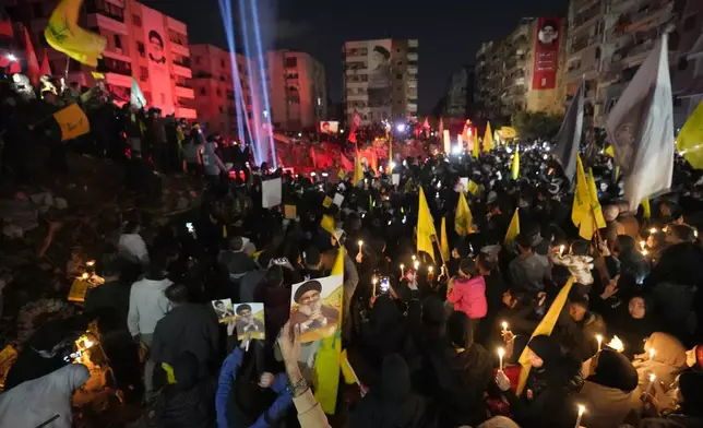 People gather at the site where former Hezbollah leader Sayyed Hassan Nasrallah was killed by Israeli airstrikes late September during a memorial ceremony in Dahiyeh, in the southern suburb of Beirut, Lebanon, Saturday, Nov. 30, 2024. (AP Photo/Hussein Malla)