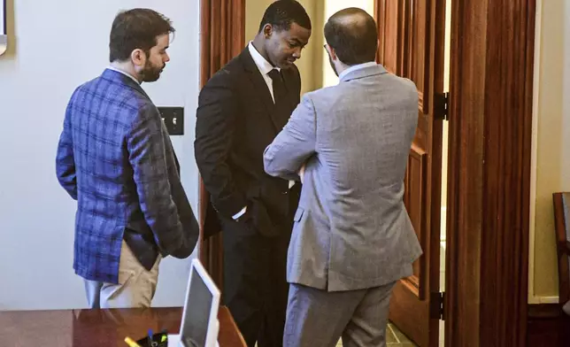 Sheldon Timothy Herrington Jr., center, who is on trial for the murder of University of Mississippi student Jimmie "Jay" Lee, talks with his attorneys as the jury deliberates on the case, at the Lafayette County Courthouse in Oxford, Miss. on Wednesday, Dec. 11, 2024. (Bruce Newman/The Northeast Mississippi Daily Journal via AP, Pool)