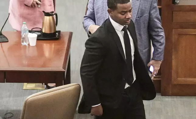 Sheldon "Timothy" Herrington Jr., foreground, who was on trial for the murder of University of Mississippi student Jimmie "Jay" Lee, and his defense team leave court after a mistrial was declared, at the Lafayette County Courthouse in Oxford, Miss. on Wednesday, Dec. 11, 2024. (Bruce Newman/The Northeast Mississippi Daily Journal, via AP, Pool)