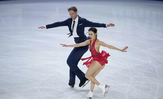 Madison Chock and Evan Bates, of the United States, compete in the ice dance's rhythm dance segment at the ISU Grand Prix Finals of Figure Skating, Friday, Dec. 6, 2024, in Grenoble, France. (AP Photo/Laurent Cipriani)