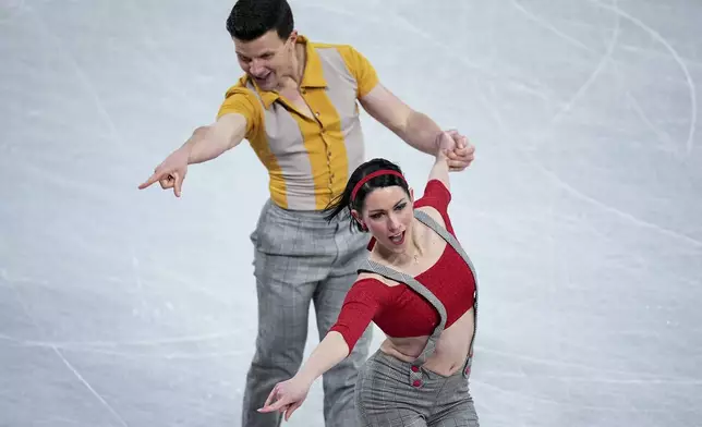 Charlene Guignard and Marco Fabbri, of Italy, compete in the ice dance's rhythm dance segment at the ISU Grand Prix Finals of Figure Skating, Friday, Dec. 6, 2024, in Grenoble, France. (AP Photo/Laurent Cipriani)